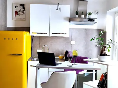 a kitchen with a desk with a laptop on it at Fornaci 8 - Loft in Vatican in Rome