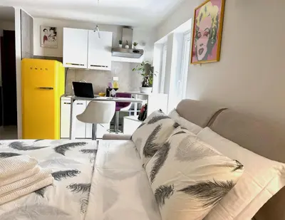 a living room with a couch and a kitchen at Fornaci 8 - Loft in Vatican in Rome