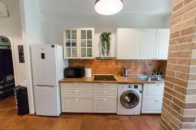 a kitchen with a refrigerator and a washing machine at Irnerio house in Rome