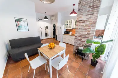 a living room with a table and a couch at Irnerio house in Rome