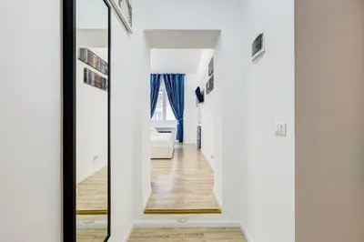 a hallway leading to a bedroom with a mirror at Ripetta Central Suites in Rome