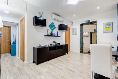 a living room with white walls and a wooden floor at Ripetta Central Suites in Rome