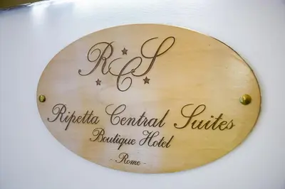 a round wooden sign with the name of auc ultra centric institutes alternative at Ripetta Central Suites in Rome