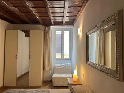 a room with a window and a couch and a mirror at Campo dei fiori Suite in Rome