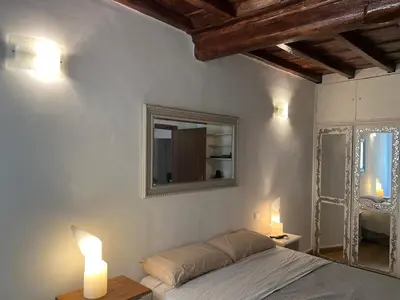 a bedroom with a bed and a mirror on the wall at Campo dei fiori Suite in Rome