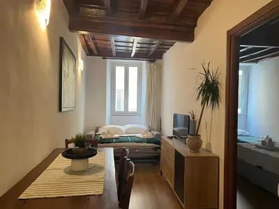a room with a dining table and a bed at Campo dei fiori Suite in Rome