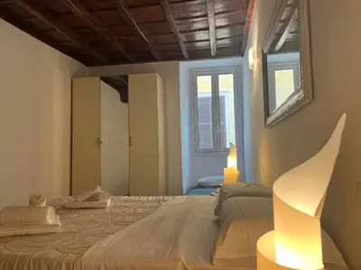 a bedroom with a large bed and a window at Campo dei fiori Suite in Rome