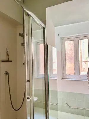 a bathroom with a shower and a window at Campo dei fiori Suite in Rome