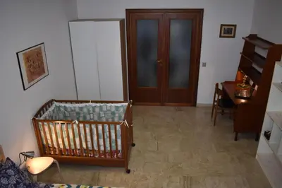 a room with a crib in front of a door at Vacanze Romane in Rome