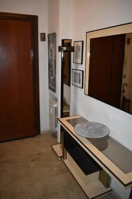 a room with a table with a mirror on the wall at Vacanze Romane in Rome