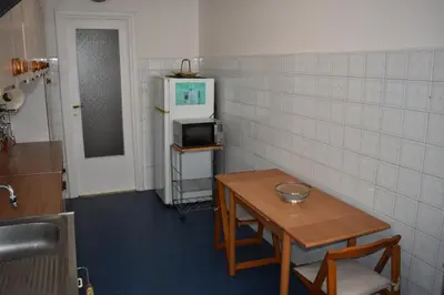 a small room with a table and a microwave at Vacanze Romane in Rome