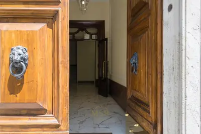 a wooden door with a dog head knocker on it at MysuiteRome in Rome