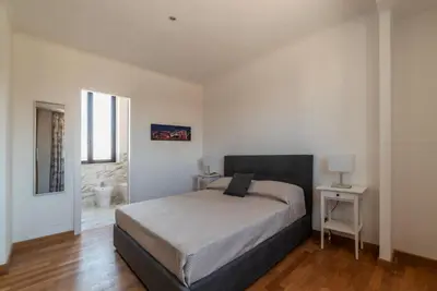 a bedroom with a bed in a white room at GuestHost - MM San Giovanni Apartment in Rome