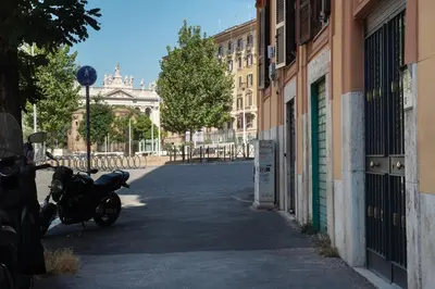 a motorcycle parked on the side of a street at GuestHost - MM San Giovanni Apartment in Rome