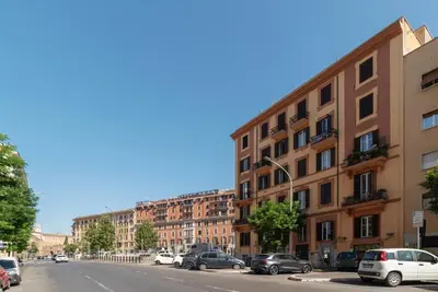 a city street with cars parked in front of buildings at GuestHost - MM San Giovanni Apartment in Rome