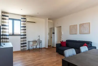 a living room with a couch and a table at GuestHost - MM San Giovanni Apartment in Rome