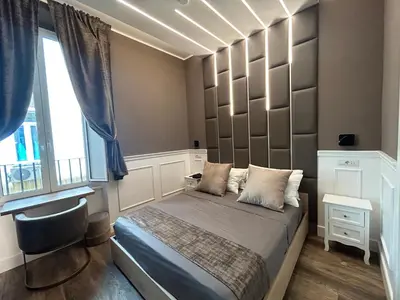 a bedroom with a bed with a large headboard at Lary's - Vaticano in Rome