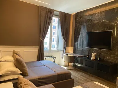 a bedroom with a bed and a flat screen tv at Lary's - Vaticano in Rome