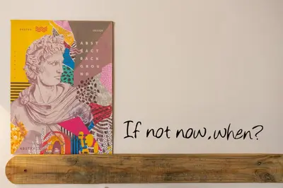 a sign that says if not now when with two posters at Casa ZOE in Rome