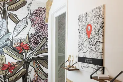 a hallway with a wall mural of a bird at Casa ZOE in Rome