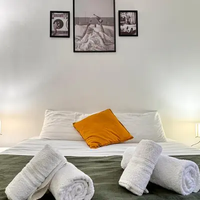 a bed with towels on it in a bedroom at Bella Roma Stay in Rome