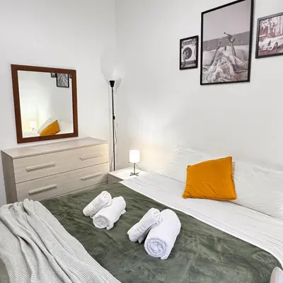 a bedroom with a bed with towels on it at Bella Roma Stay in Rome