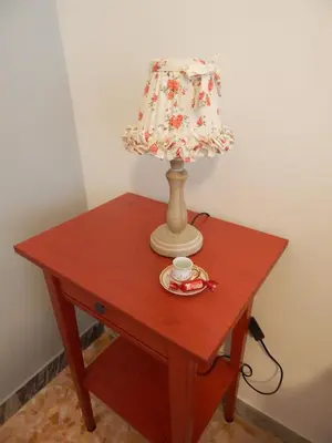 a table with a lamp and a cup on it at Affittacamere Roma Centro, Musei Vaticani Rooms in Rome