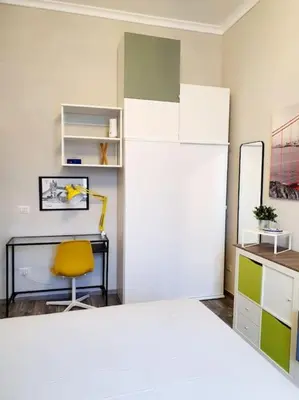a room with a bed and a desk and a chair at Charming house in Rome