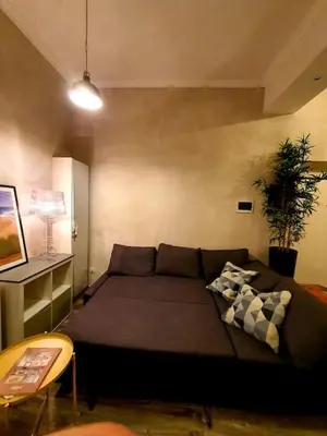 a living room with a couch and a table at Charming house in Rome