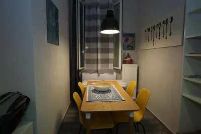 a dining room with a table and yellow chairs at Charming house in Rome