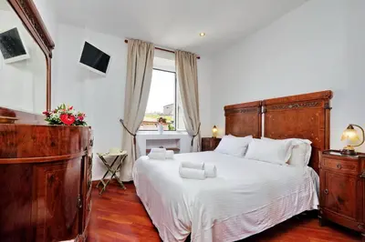 a bedroom with a large bed and a window at Terrazze Navona in Rome