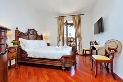 a bedroom with a large bed and a television at Terrazze Navona in Rome