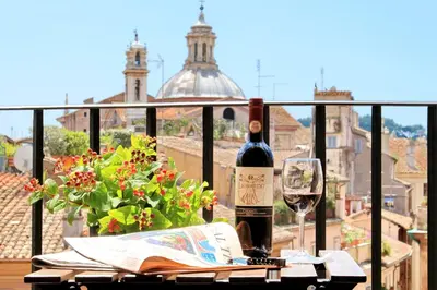 a bottle of wine sitting on a table with a glass at Terrazze Navona in Rome