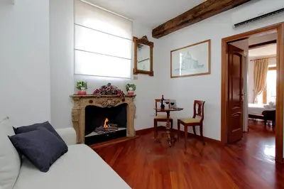 a living room with a fireplace and a table at Terrazze Navona in Rome