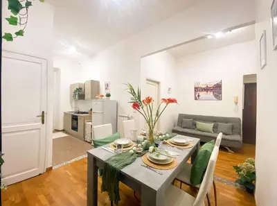 a living room with a table and a couch at Via Veneto - Domus Juliae in Rome