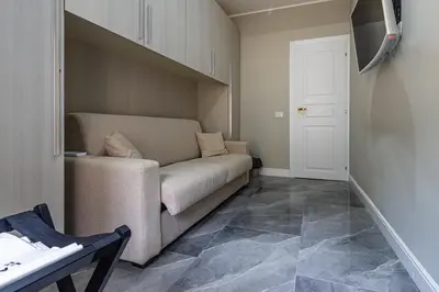 a living room with a couch and a table at RANALLI Suite in Rome