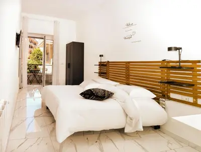 a white bedroom with a large bed and a sink at B&Baldo Vatican in Rome