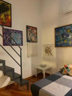 a dining room table with chairs and a tv at La casa di Barcri in Rome