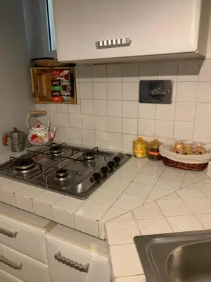 a counter with a mixer and a basket of bread at La casa di Barcri in Rome