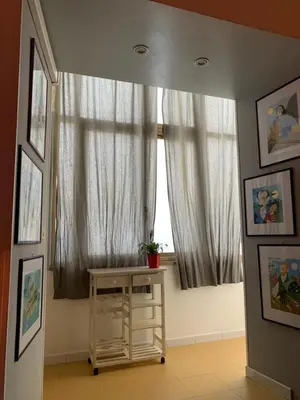 a living room with a staircase and a bed at La casa di Barcri in Rome