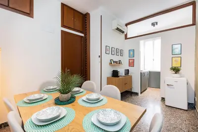 a dining room with a wooden table and chairs at Vatican Flower Apartment in Rome