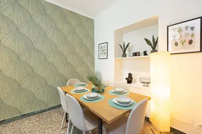a dining room with a wooden table and chairs at Vatican Flower Apartment in Rome