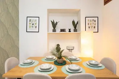 a dining room with a wooden table and chairs at Vatican Flower Apartment in Rome