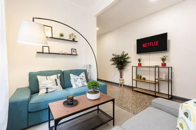 a living room with a blue couch and a table at Vatican Flower Apartment in Rome