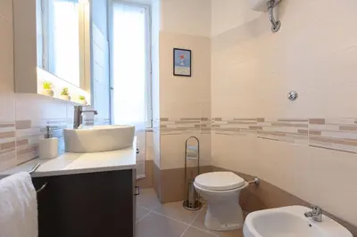 a bathroom with a sink and a toilet at Vatican Flower Apartment in Rome
