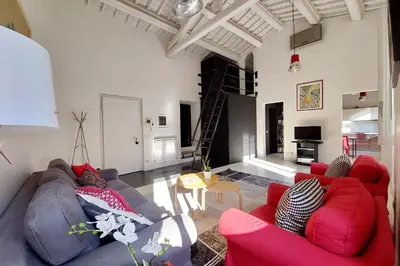 a living room with a couch and a table at Trastevere Design Loft - My Extra Home in Rome