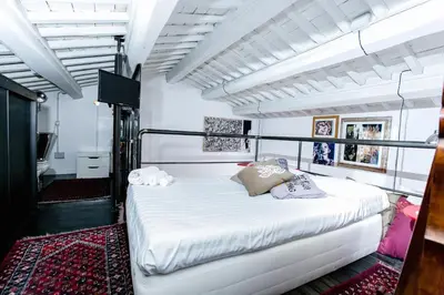 a bedroom with a large white bed in a room at Trastevere Design Loft - My Extra Home in Rome