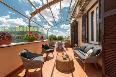 a balcony with furniture and a glass roof at Coppede' Penthouse in Rome