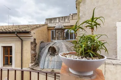 a plant in a pot on a balcony with a building at Pantheon Splendid Flat with Terrace in Rome