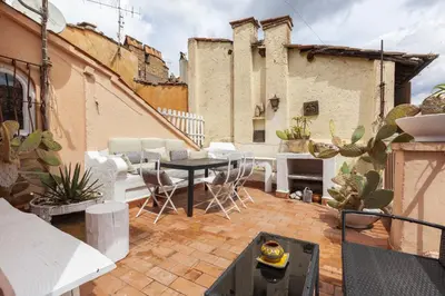 a rooftop patio with a table and chairs and cactus at Pantheon Splendid Flat with Terrace in Rome